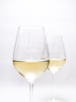 clear wine glass with yellow liquid