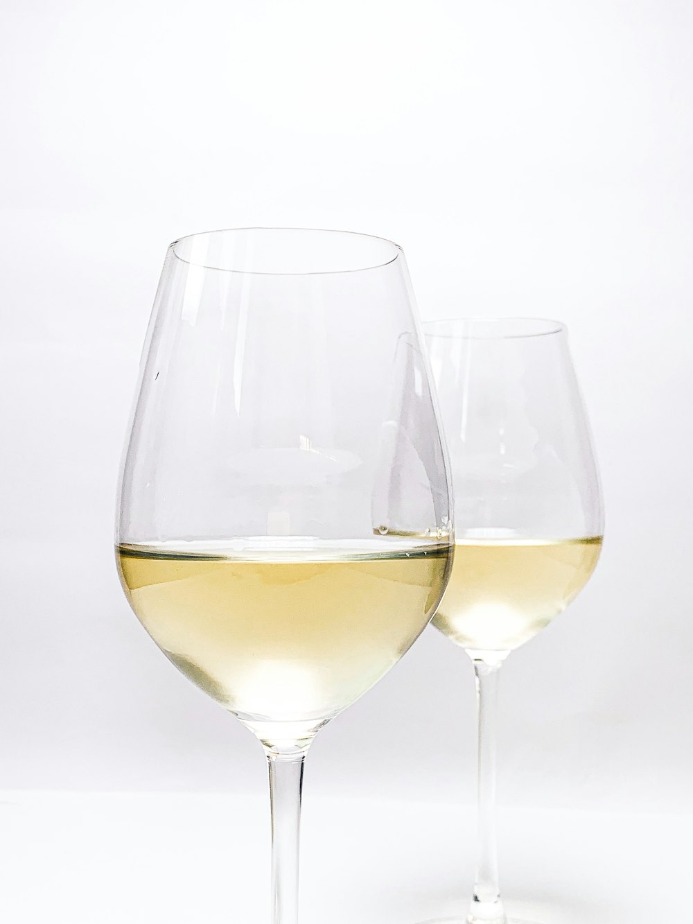 Bicchiere da vino trasparente con liquido giallo