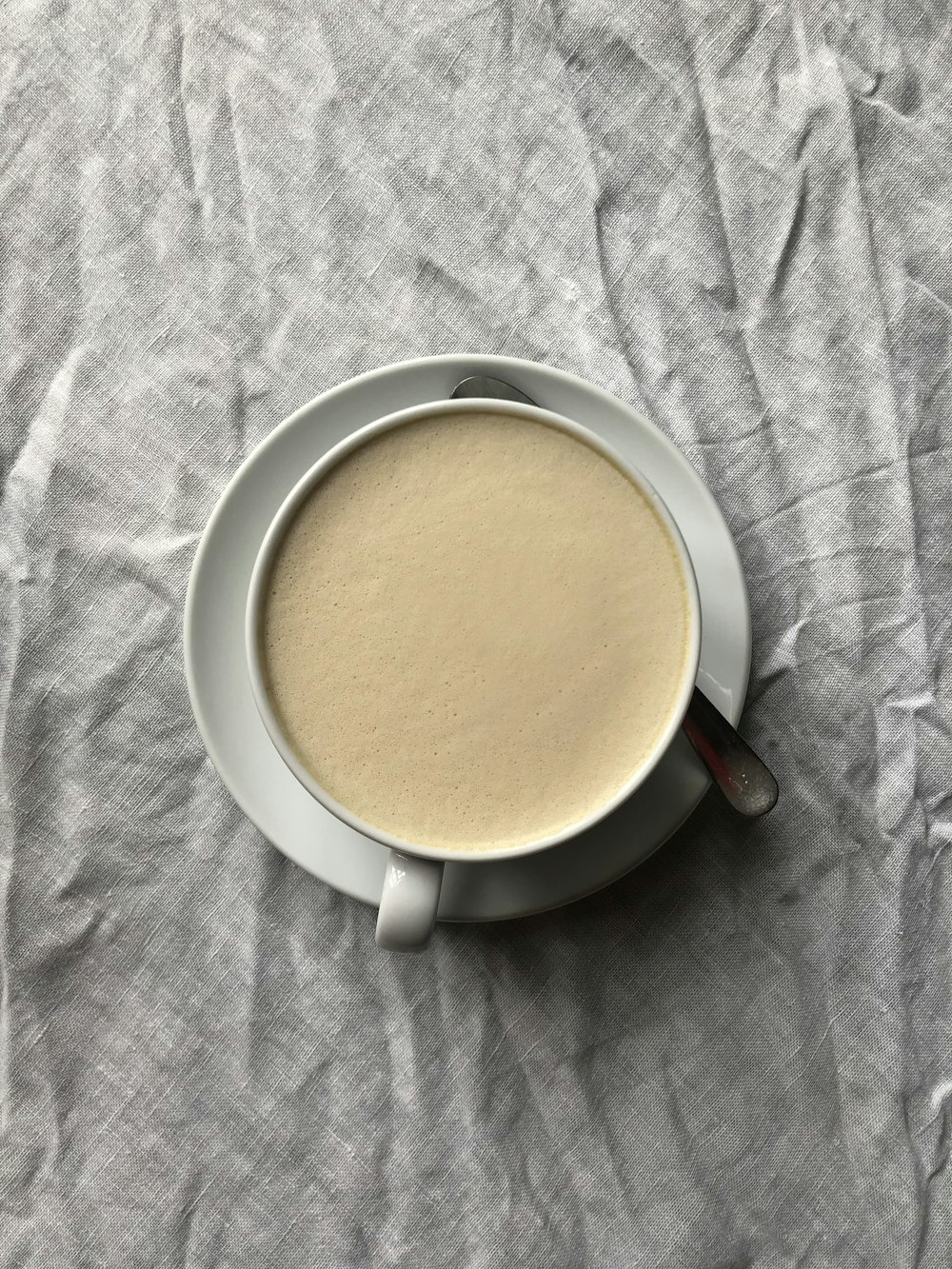 white ceramic mug with brown liquid