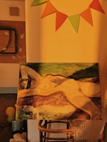 Finished abstract body print painting displayed on a wooden easel in a warmly lit room