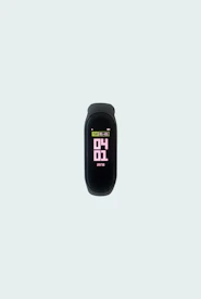 Close-up of sleek fitness trackers glowing softly on a modern black surface.