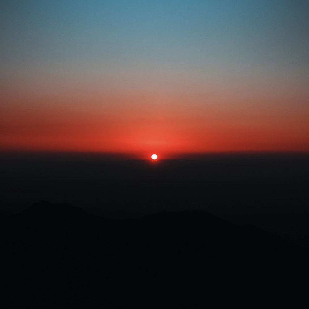 silhouette of mountain during sunset