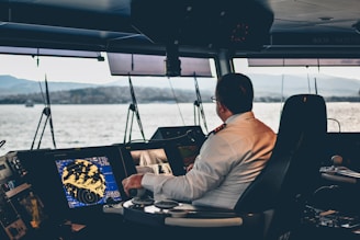 man in white dress shirt sitting on black chair