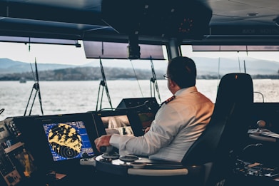man in white dress shirt sitting on black chair