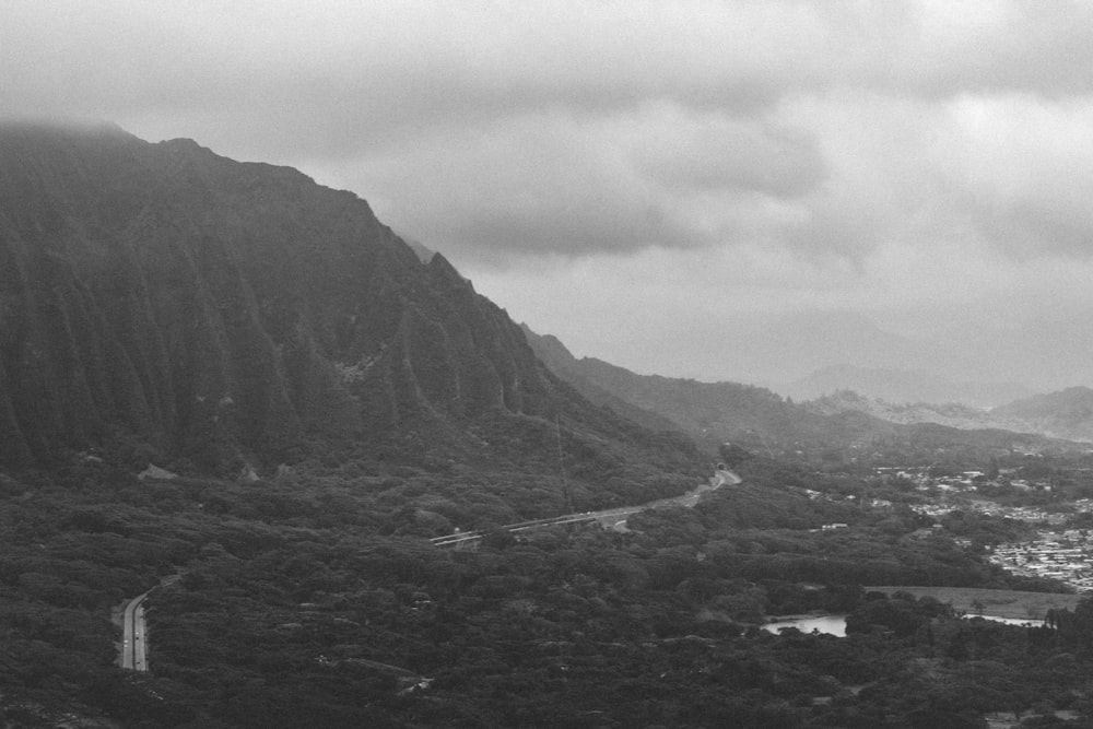 grayscale photo of mountains and river