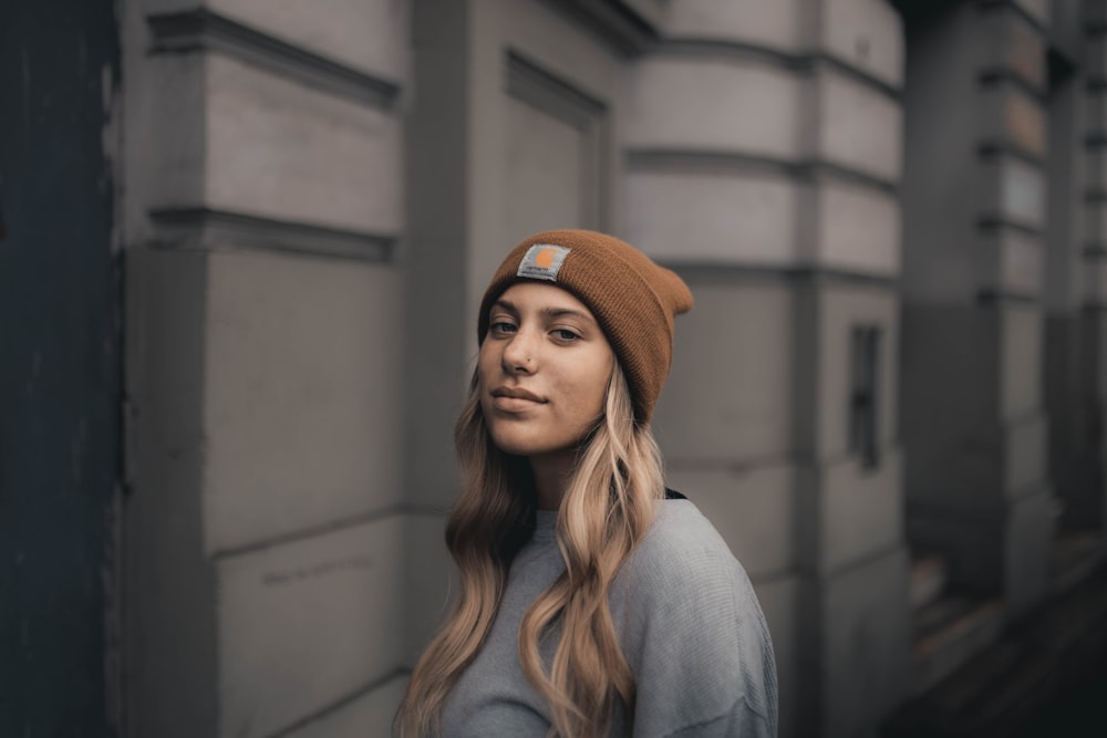 woman in gray long sleeve shirt wearing orange knit cap