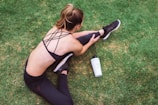 woman in black lingerie holding white bottle