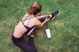 woman in black lingerie holding white bottle