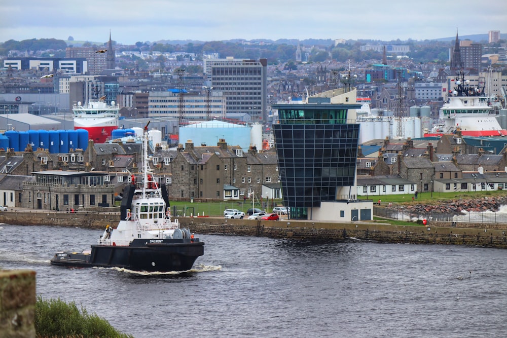 black and white boat on water near city buildings during daytime