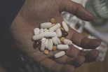 white oval medication pill on persons hand