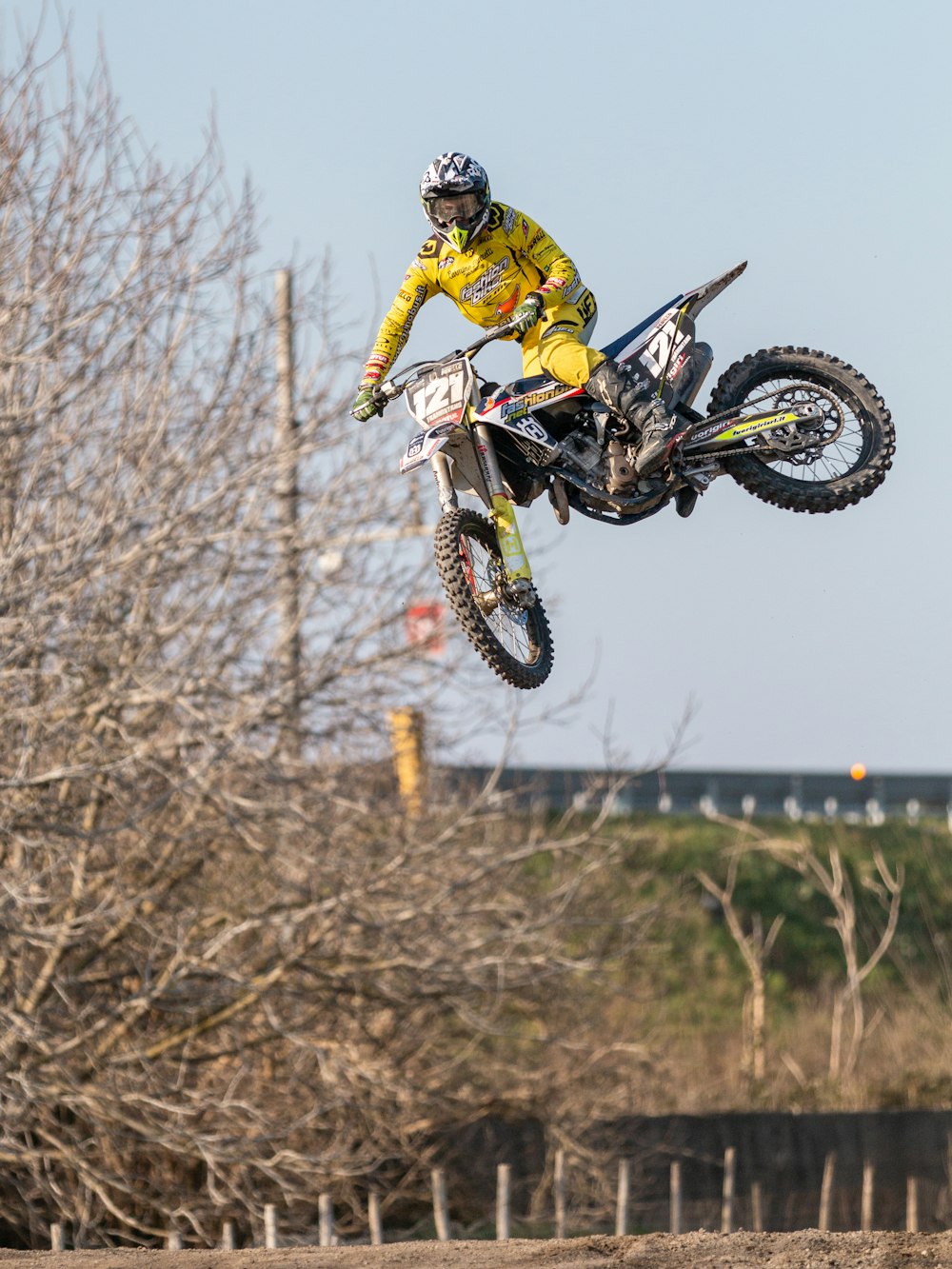 man in yellow and black motocross suit riding motocross dirt bike