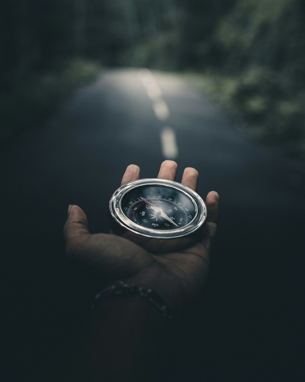 person holding silver round container