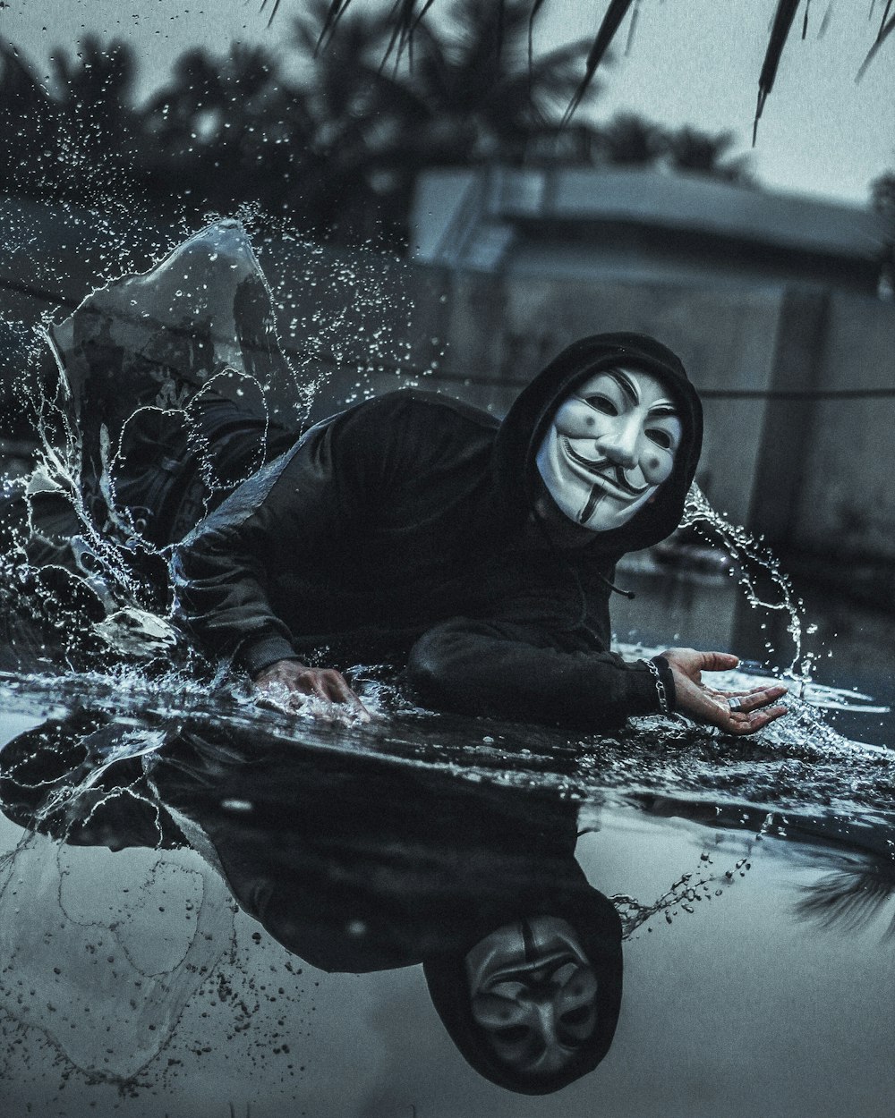 woman in black leather jacket and black hijab sitting on water