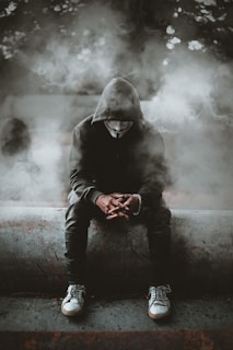 man in black hoodie and black pants