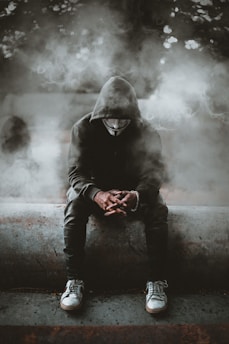 man in black hoodie and black pants