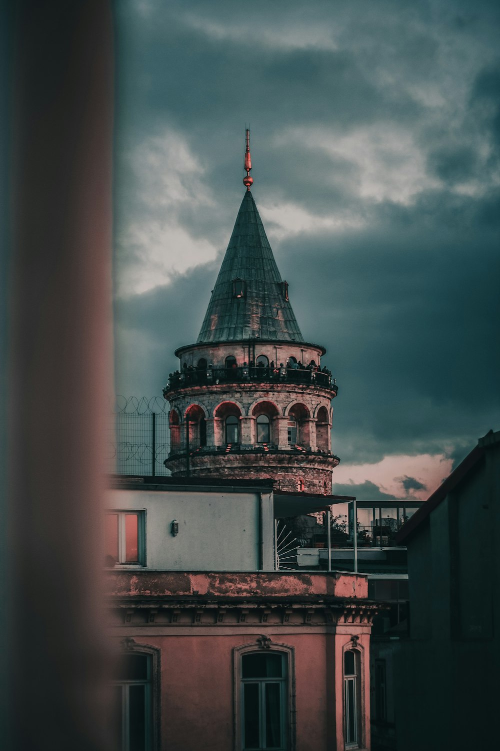 brown and green concrete building under cloudy sky during daytime