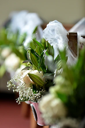 Close-up of intricate floral arrangements decorating the wedding aisle.
