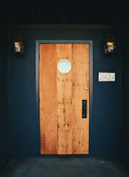brown wooden door with black and white wall mounted device