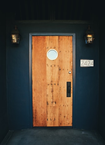 brown wooden door with black and white wall mounted device