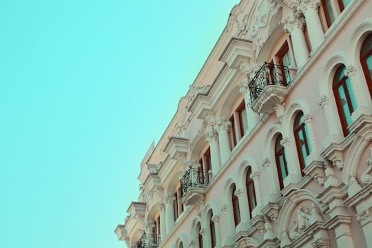 white concrete building under blue sky during daytime in Quito Ecuador