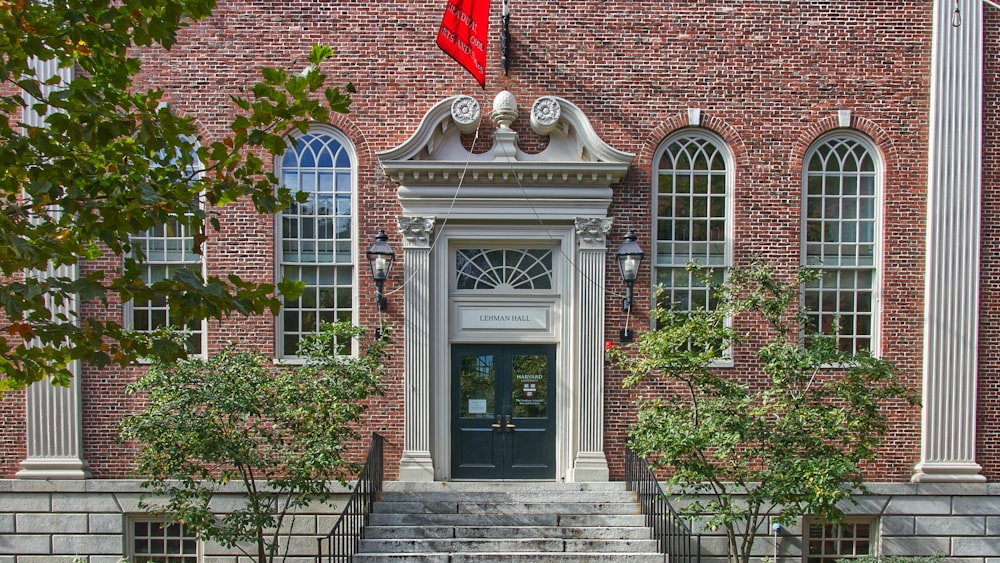 brown brick building with green plants