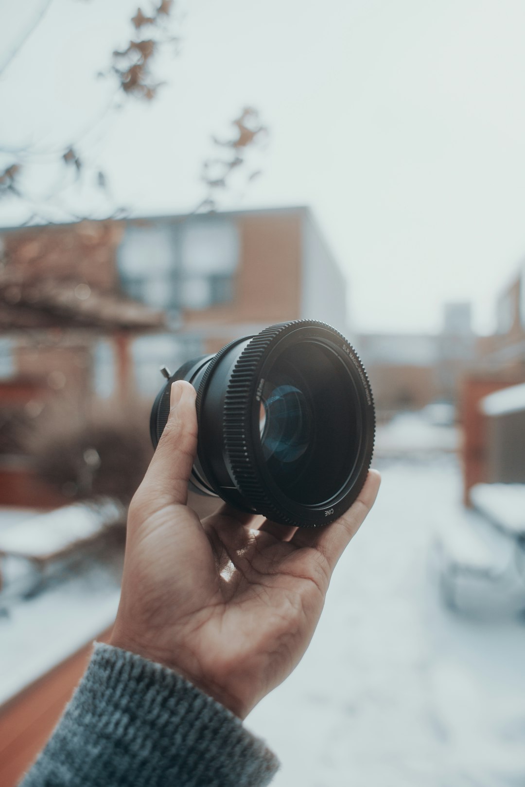 person holding black camera lens