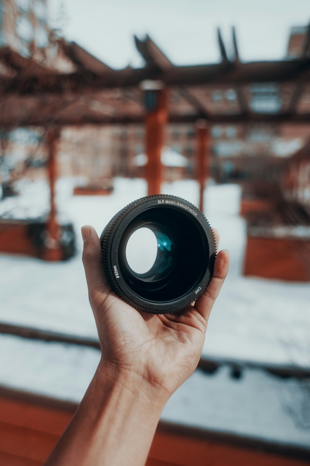 person holding black camera lens