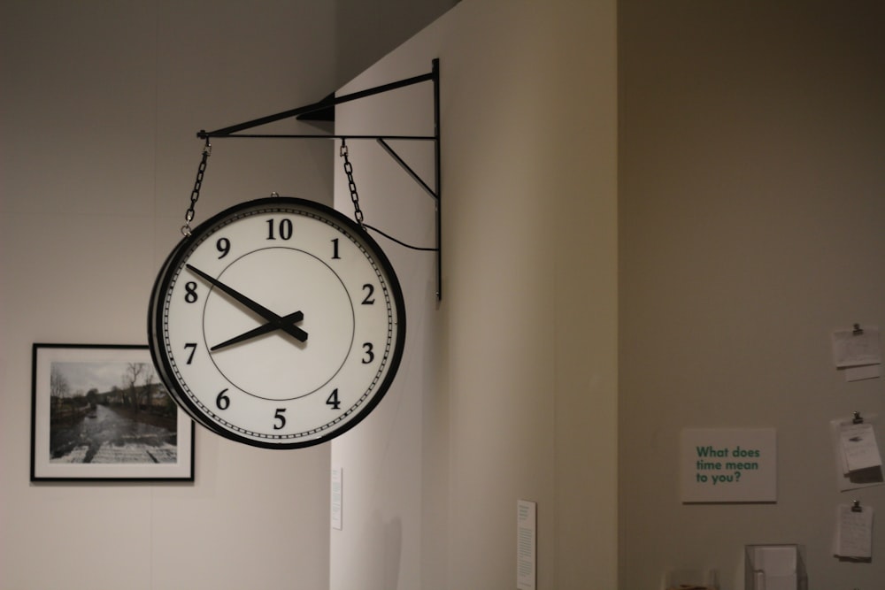 black and white analog wall clock at 10 00