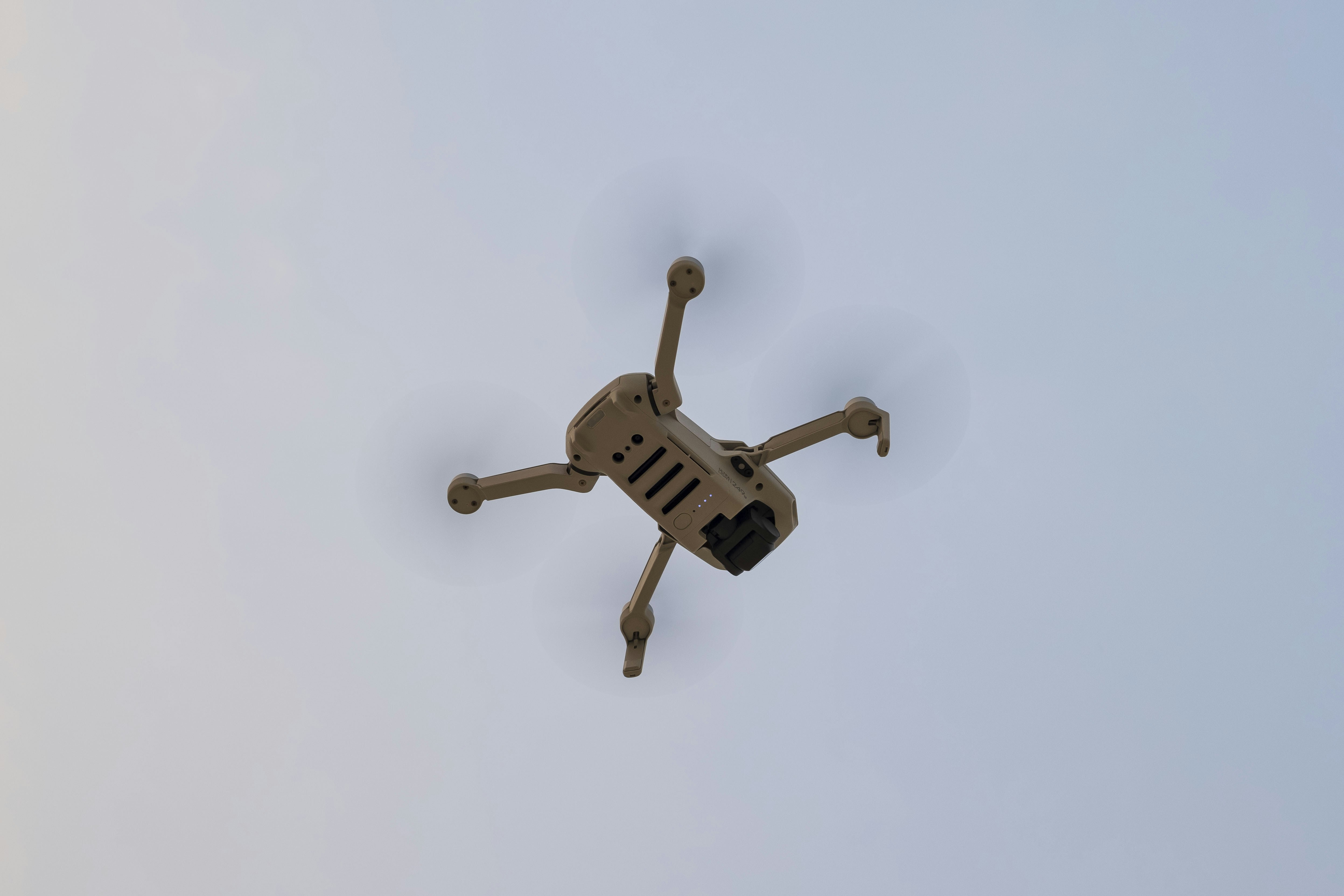 white and black drone in mid air