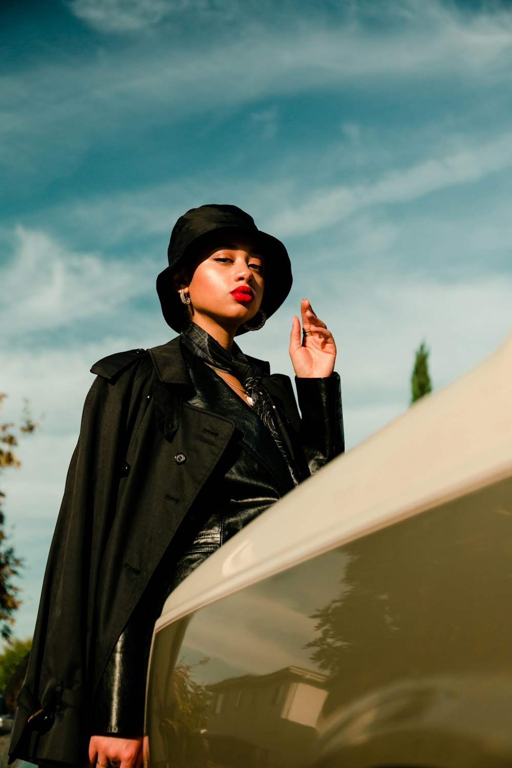 woman in black coat and black hat