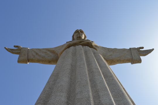 low angle photography of statue of liberty under blue sky during daytime in Cristo-Rei Portugal