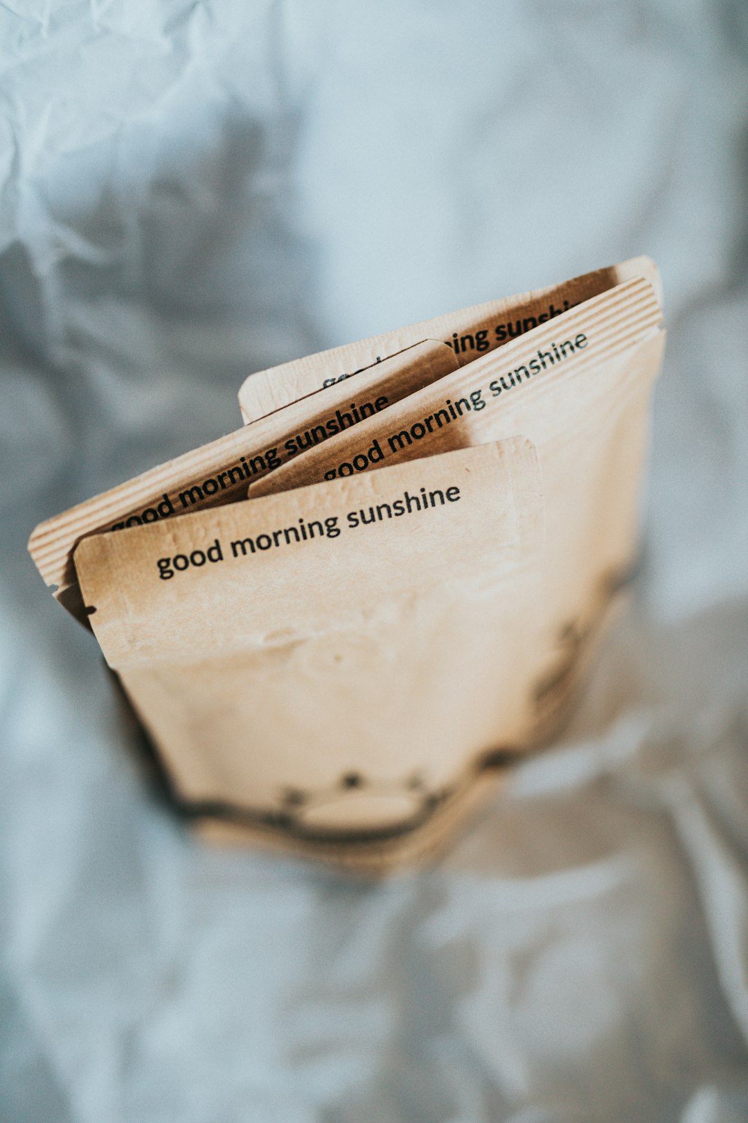 brown paper bag on white textile