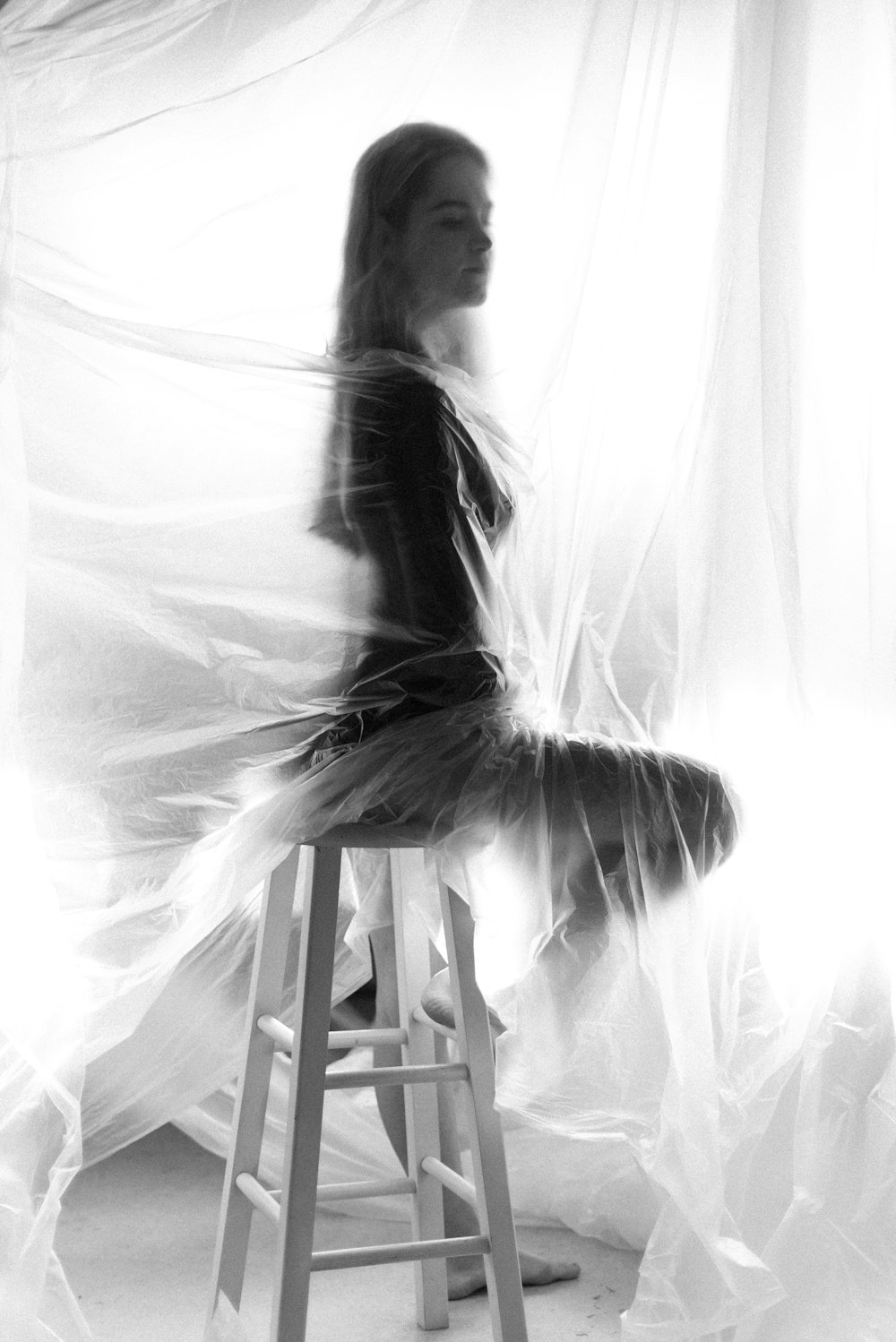 woman in white dress sitting on white wooden chair