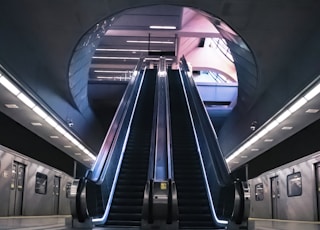 blue and white escalator in a train station