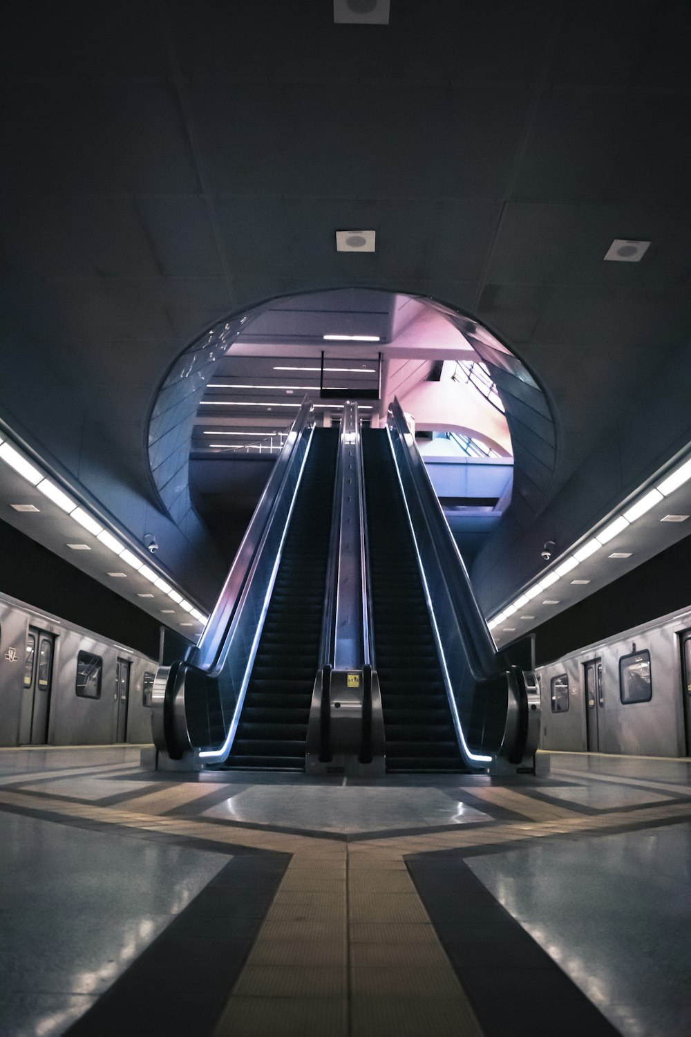 blue and white escalator in a train station