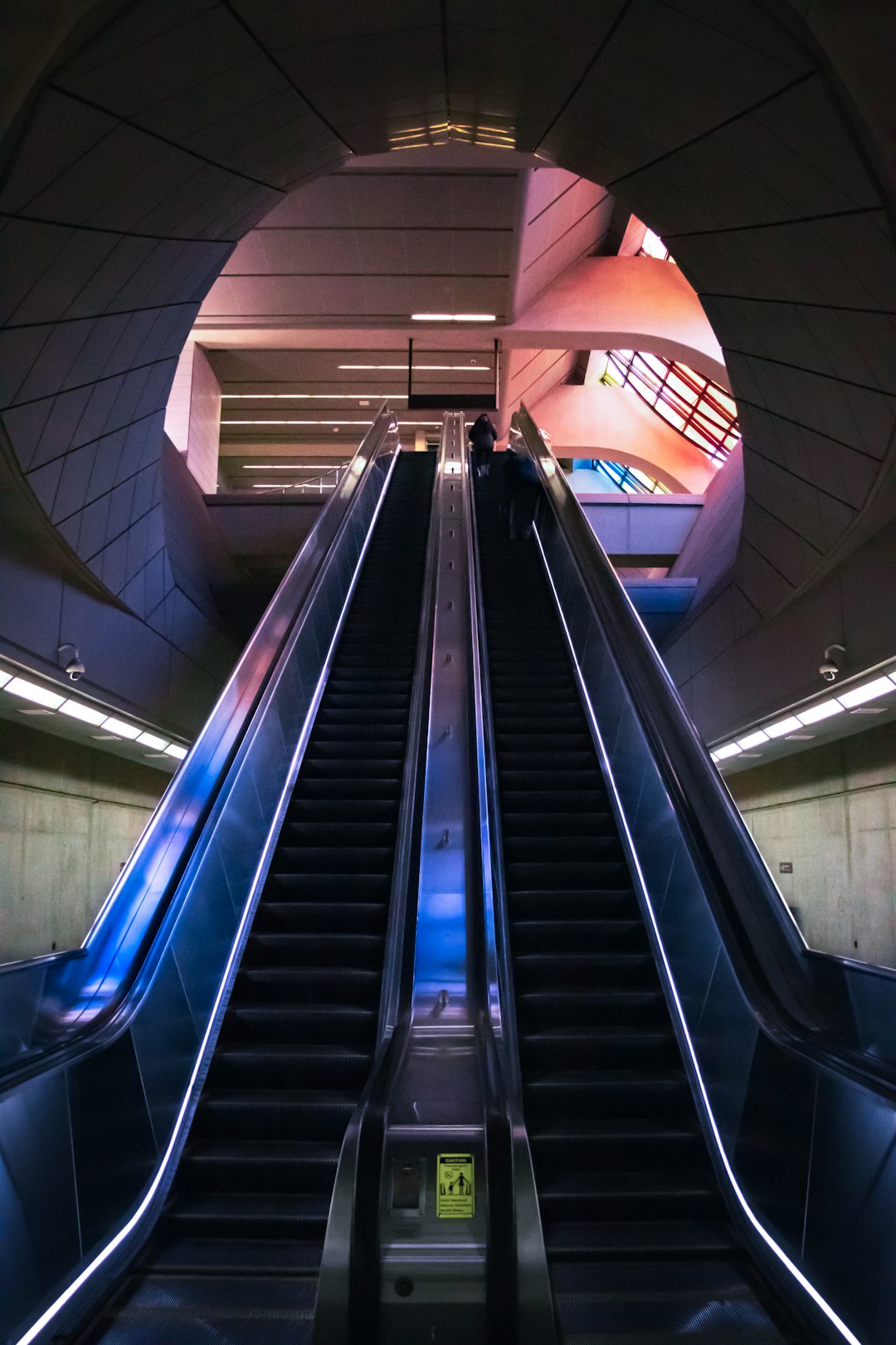 black escalator in a white and blue building