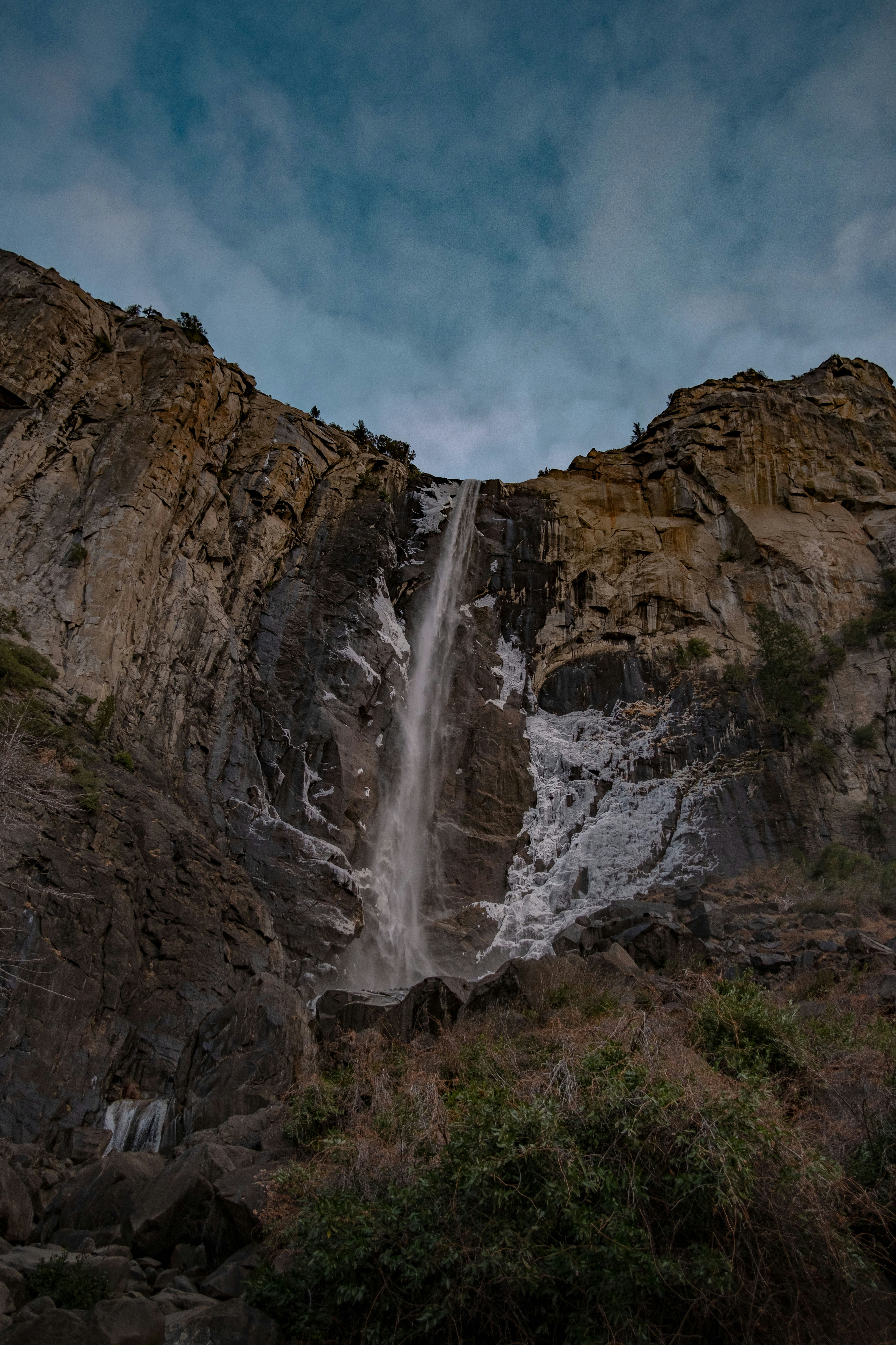 waterfalls under blue sky and white clouds during daytime