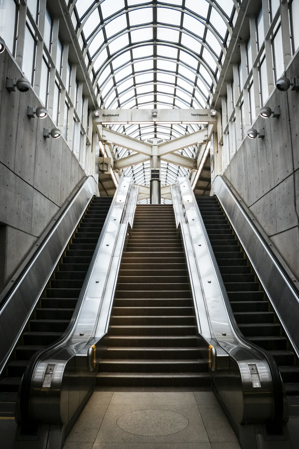 white and brown escalator in a building