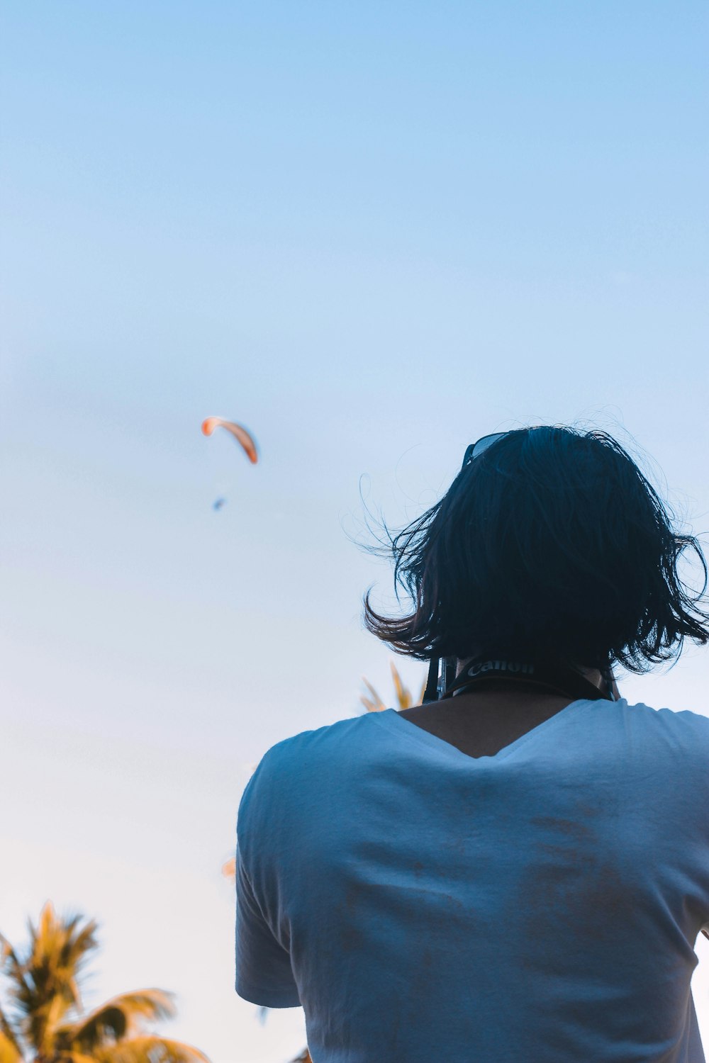 woman in blue shirt looking at the sky during daytime