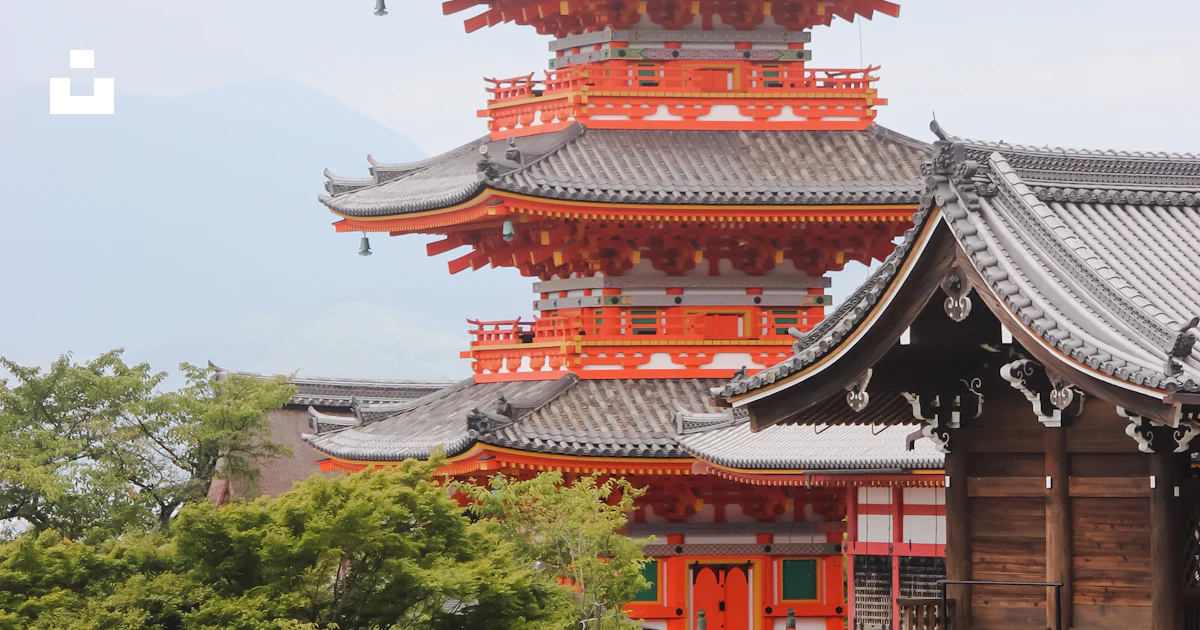 Red and white temple surrounded by green trees during daytime photo ...