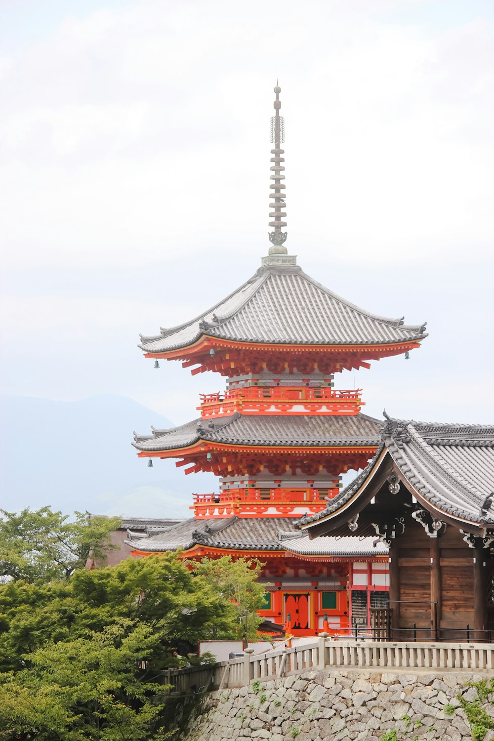 red and white temple surrounded by green trees during daytime