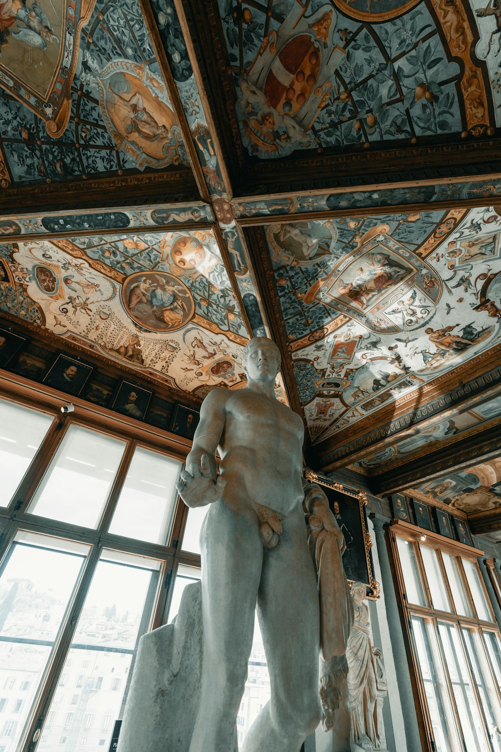 white concrete statue on brown wooden ceiling