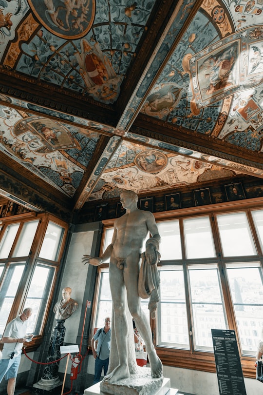 white concrete statue inside building in Uffizi Gallery Italy