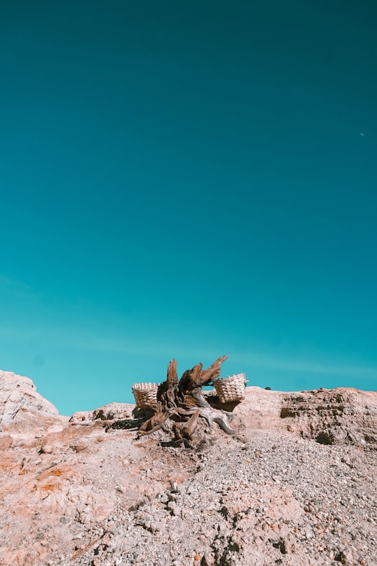 brown rock formation under blue sky during daytime in Ijen Indonesia