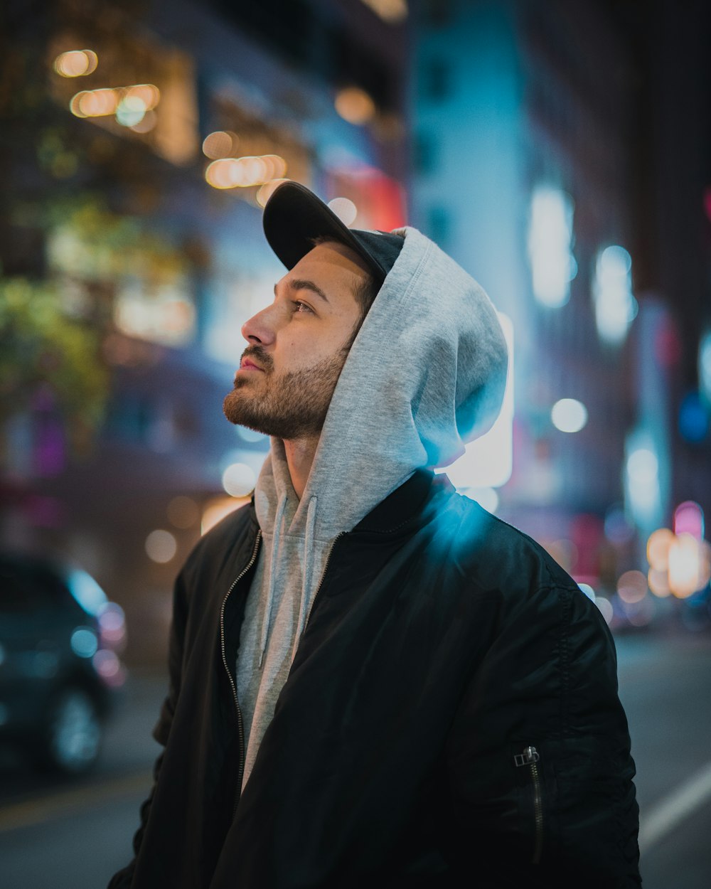 man in black leather jacket and gray knit cap