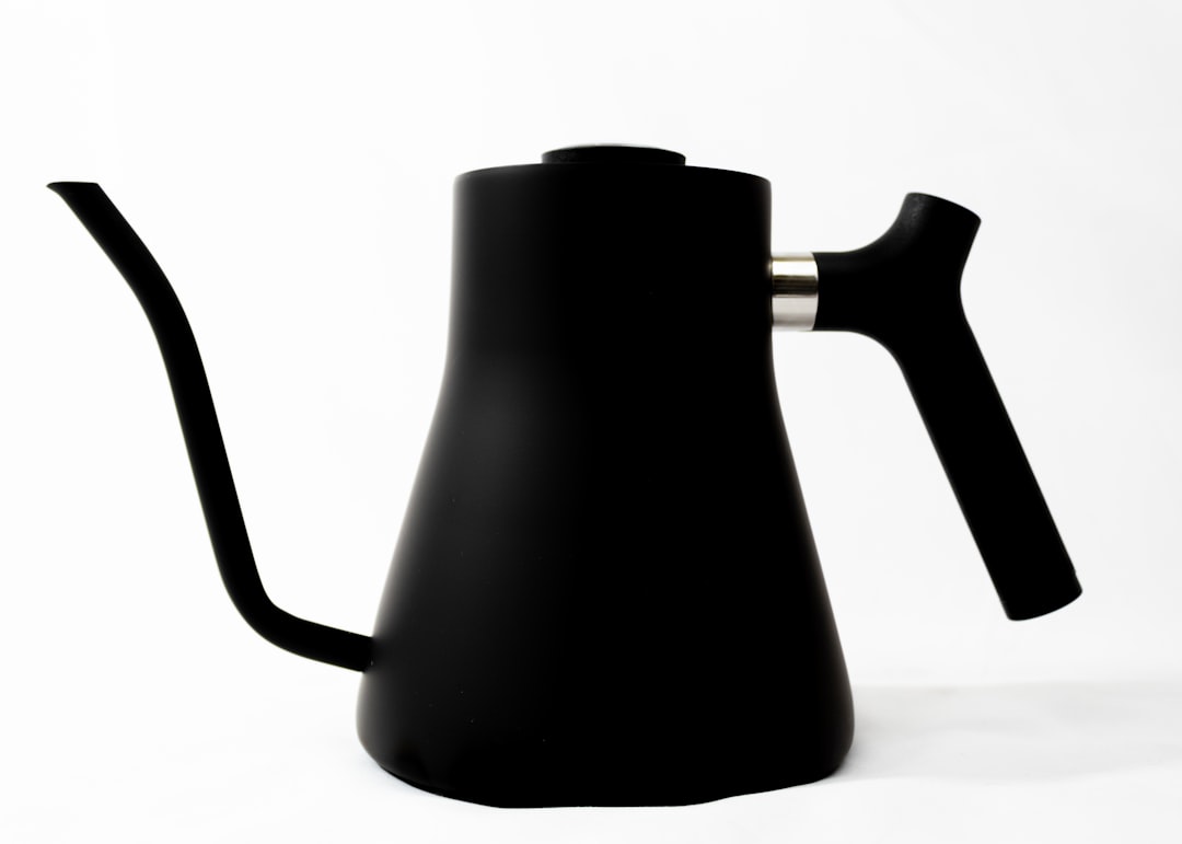 black ceramic pitcher on white table