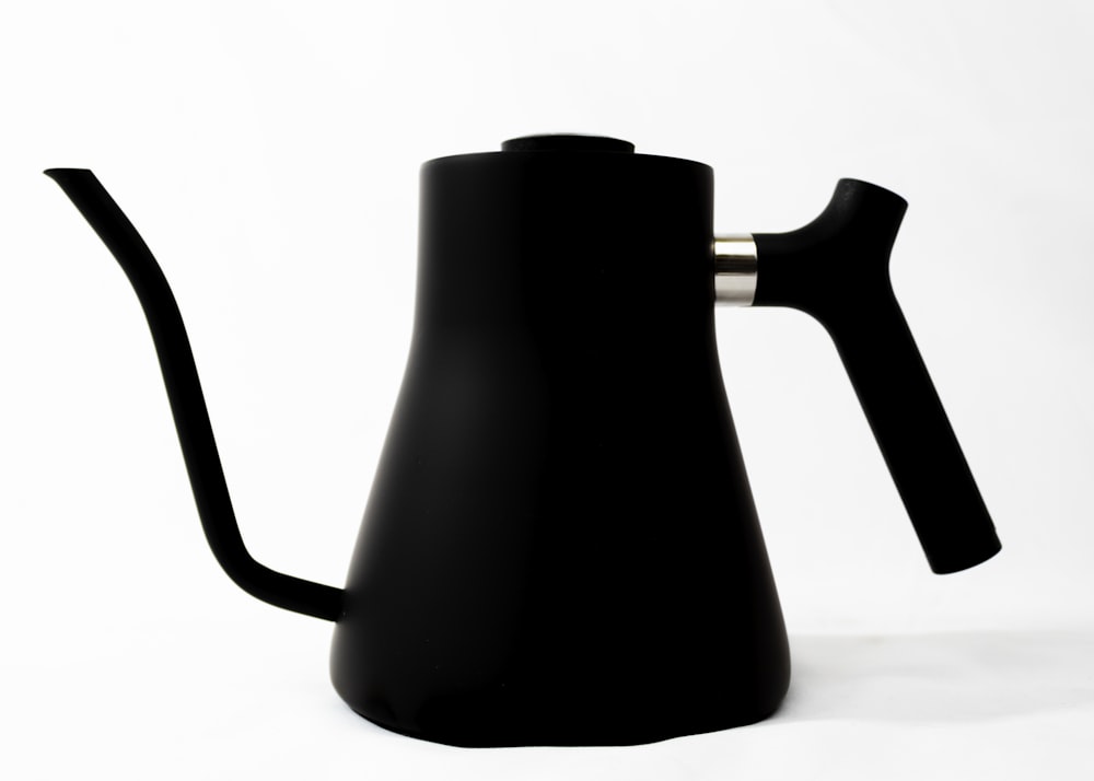 black ceramic pitcher on white table