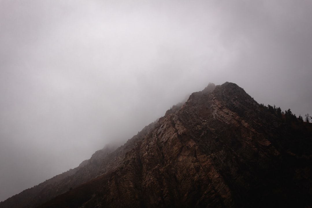 brown mountain under white clouds