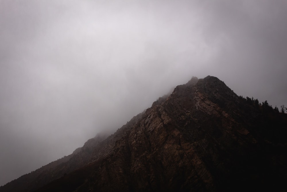 brown mountain under white clouds