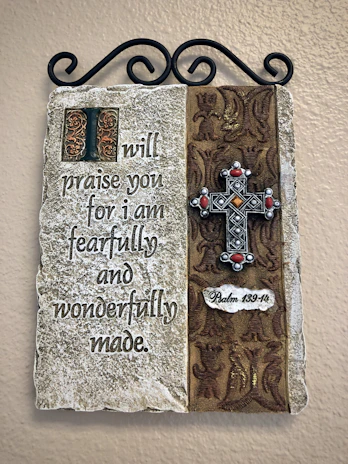 A handwritten note with the phrase 'I am fearfully and wonderfully made' beside a blooming flower.